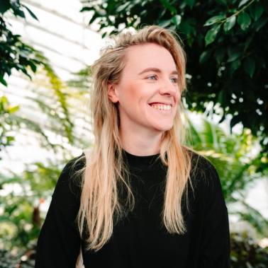 blonde young woman smiling in nature