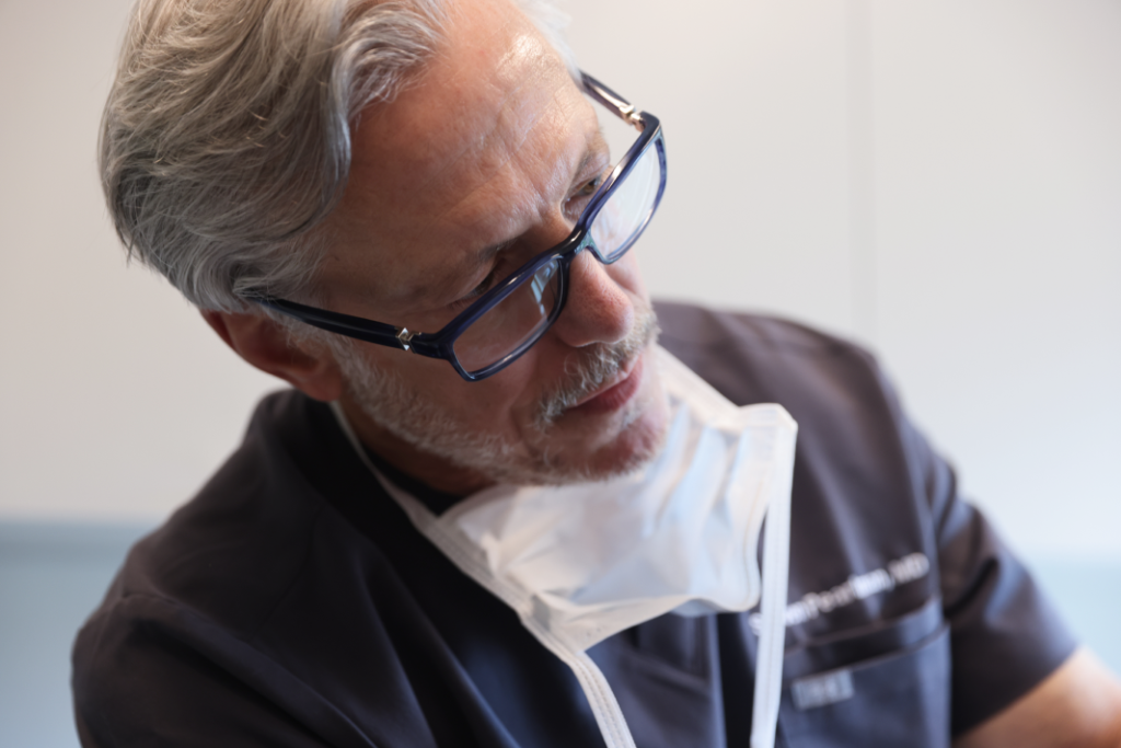 Dr. Pearlman in scrubs and glasses