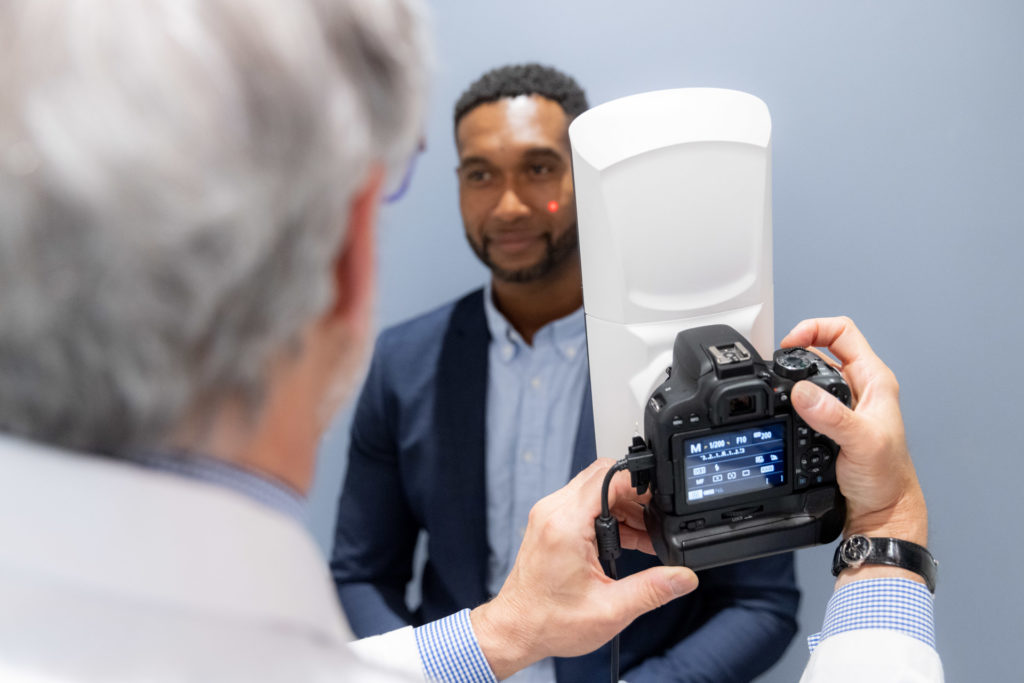 Ethnic Rhinoplasty consultant taking a picture of the patient