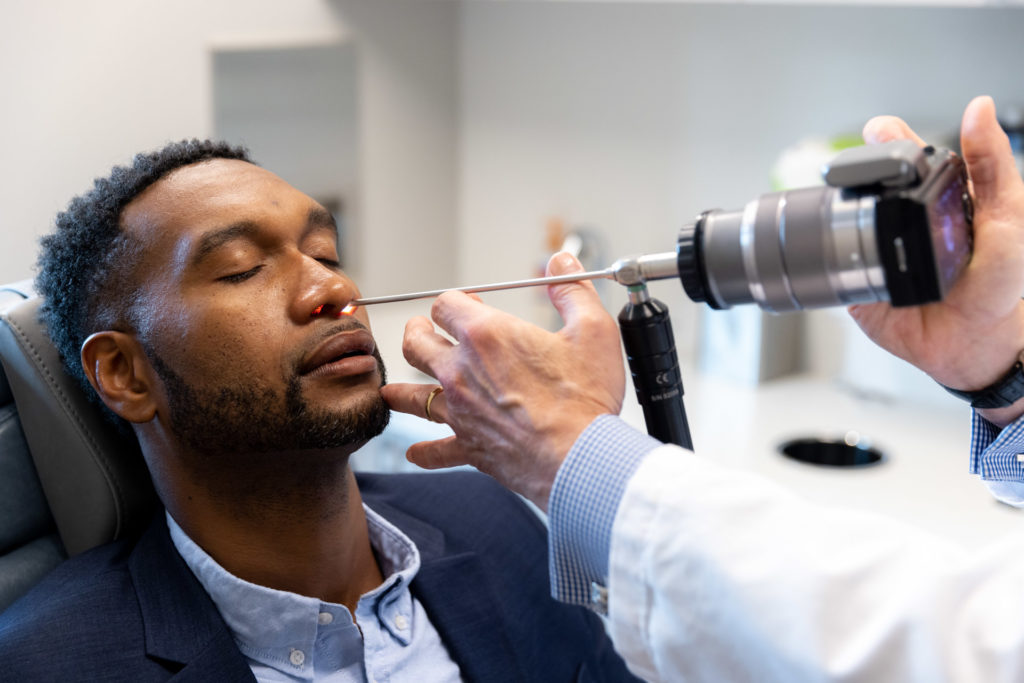 Dr. Pearlman using light tool for rhinoplasty