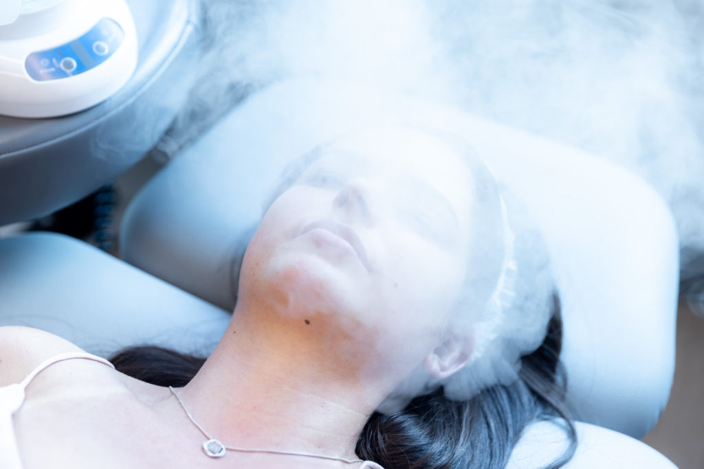Steaming patient's face during hydra facial