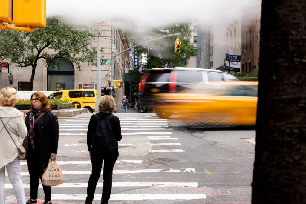 cars moving on the street and people walking