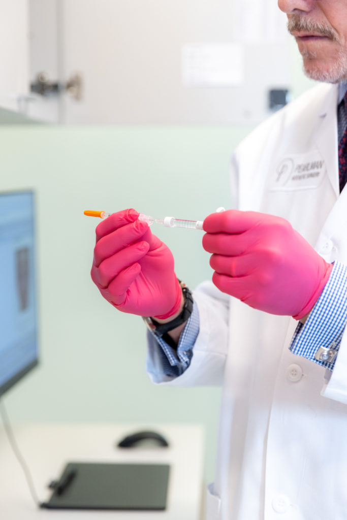 Dr. Pearlman preparing injection for nonsurgical rhinoplasty