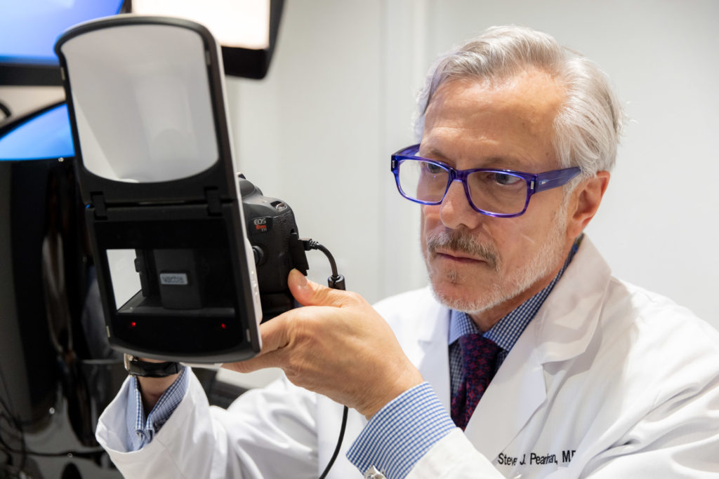 Dr. Pearlman taking patient pictures for rhinoplasty