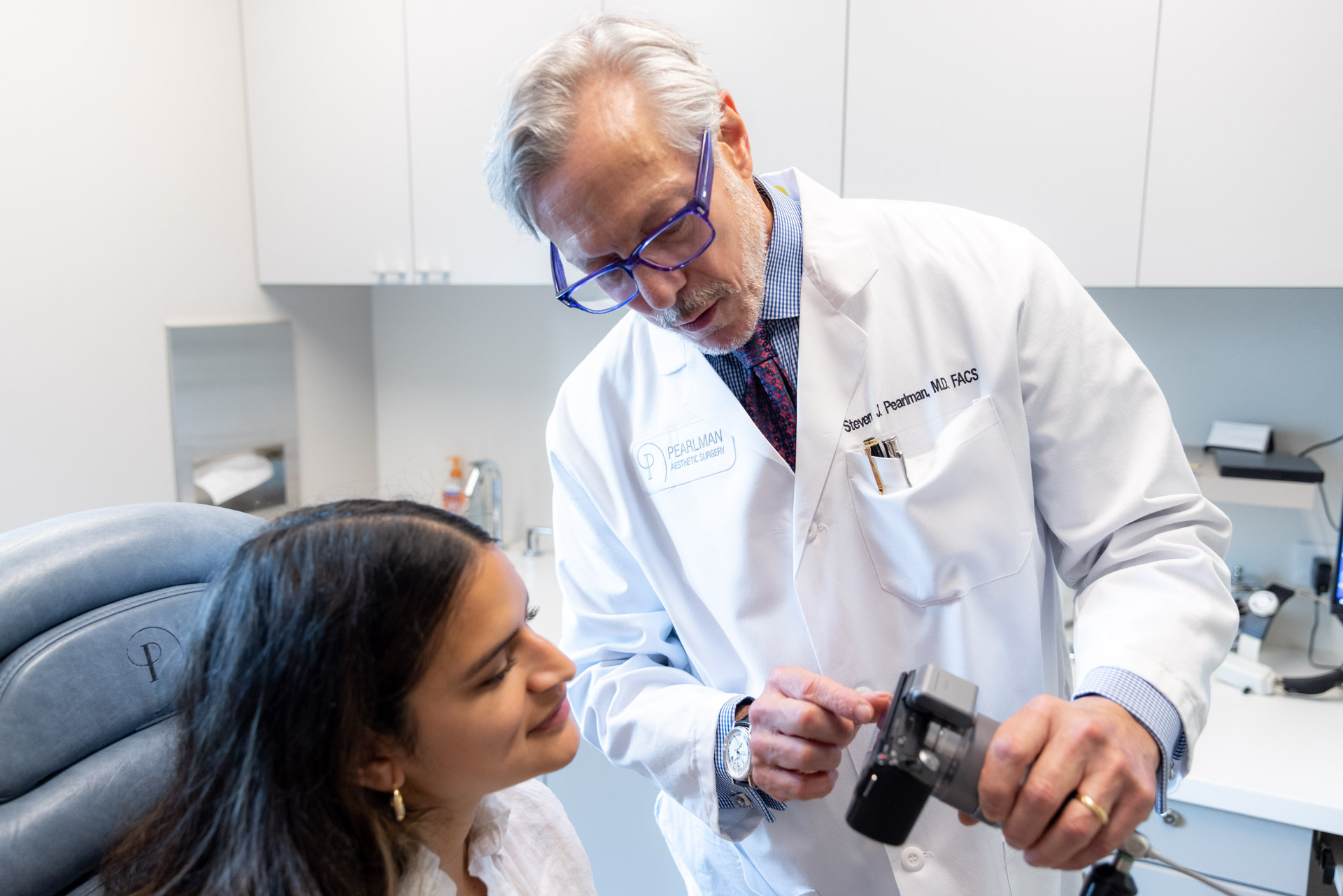 Rhinoplasty specialist showing pictures to patient