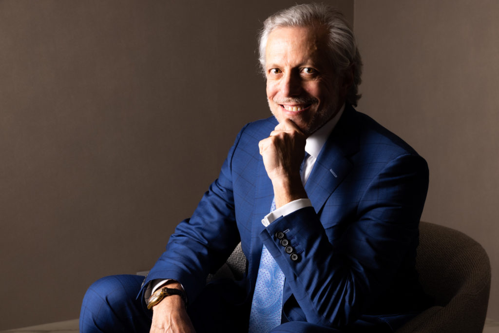 Dr. Pearlman smiling in chair