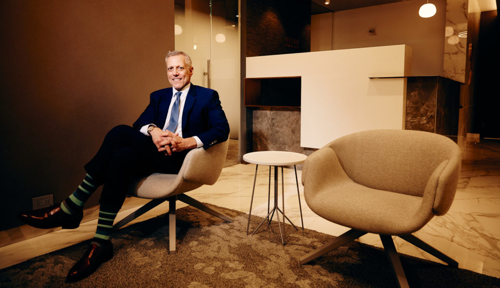 Dr. Pearlman sitting in a chair and smiling