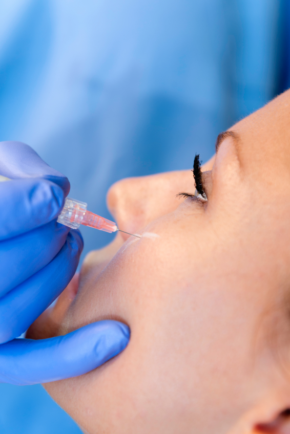 specialist injecting woman's cheek