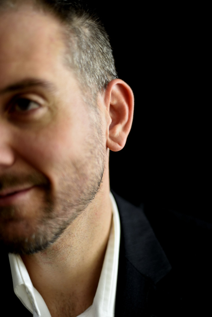 gray haired man in suit smiling