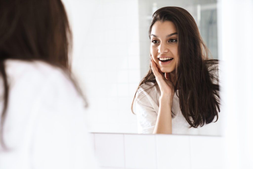woman admiring her results after a laser treatment